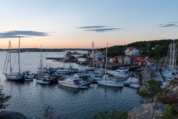 Fototapeta na wymiar View into the sailing and fishing harbour of Resö during sunset, western Sweden.