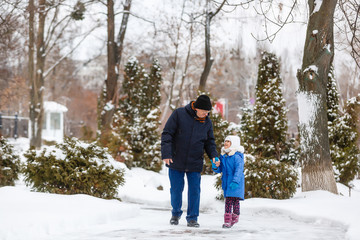 Grandfather carries granddaughter through the snow, grandfather and granddaughter spend time in...