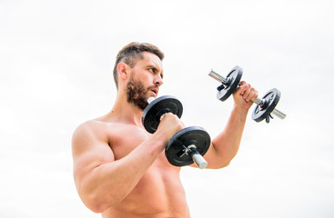 Fototapeta na wymiar Gym workout. Workout fitness sport. Workout concept. Healthy mind in a healthy body. Muscular man exercising with dumbbell. Dumbbell exercise. Dare to be great. Sportsman strong biceps triceps