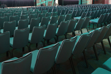 Blue empty seats in the audience prepared for the participants of the conference or presentation. 