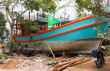 Fototapeta na wymiar Fishing boat under repair in Sichon, Nahon si Thammarat, Thailand