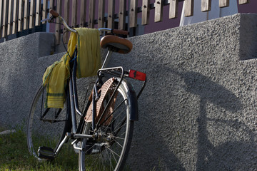 retro Bike on th wall, a bike leans against the wall with a scarf on the starring wheel 2