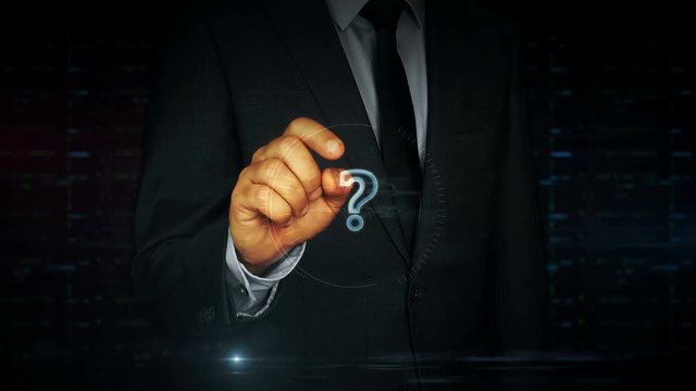 A businessman in a suit touch the screen with question mark symbol hologram. Man using hand on virtual display interface. Knowledge, faq, searching and education concept.