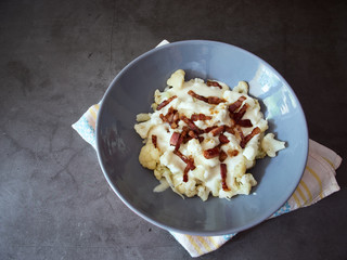 Top view of paleo cauliflower alternative to traditional potato dumplings with bryndza cheese and bacon