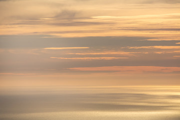 Naklejka na ściany i meble Horizon between the sea and the orange sky at sunset.