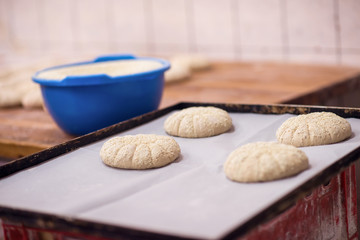 balls of dough bread getting ready to be baked