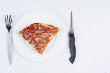A delicious homemade pizza on a plate isolated on a white background. Pizza on a plate with a knife and a fork