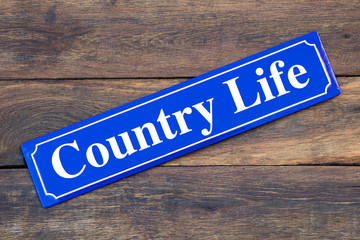 Country Life street sign on wooden background