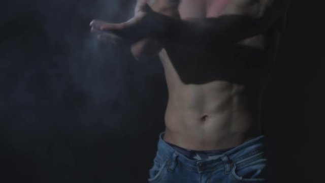 fitness man athlete hands clapping chalk powder sportsman preparing training workout in gym ready for bodybuilding strength exercise slow motion close up