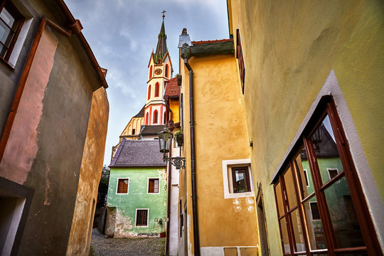 Czech Krumlov, Czech Republic. Streetview at Saint Vitus Catholic church from the medieval antique street with old houses.