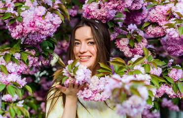 Fototapeta premium Spring time. blossom smell, allergy. woman in spring flower bloom. girl in cherry flower. Sakura tree blooming. skincare and spa. Natural cosmetics for skin. natural summer beauty