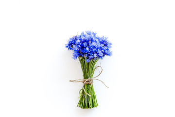 Summer flowers pattern with bouquet of blue cornflowers on white background top view mock up