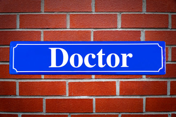 Doctor street sign on brick wall