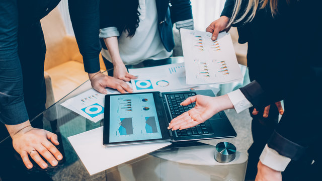 Bad investment. Cropped shot of business partners reviewing graphs and charts, discussing problems at corporate meeting.