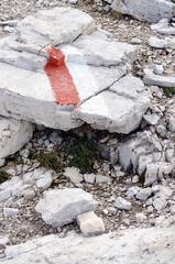 White and red paint to indicate the mountain path in Dolomites protected by UNESCO
