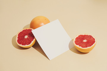 Minimal sunlit fruit composition with sand colour background and sharp shadows. Summer creative copy space.