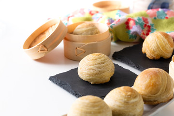 Oriental food concept homemade organic Huaiyang Spiral Chinese flaky  pastry moon cake on white background with copy space