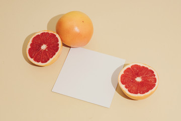 Minimal sunlit fruit composition with sand colour background and sharp shadows. Summer creative copy space.