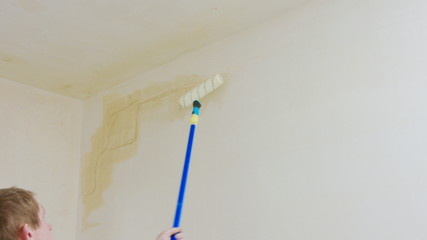 Man painting the room white. Decoration