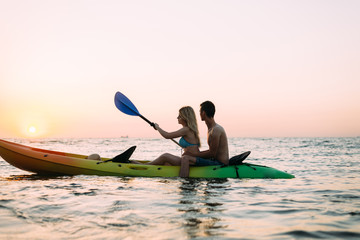 kayak walk on the Sri Lanka coast. Young loving couple celebrates their honeymoon and meets the dawn