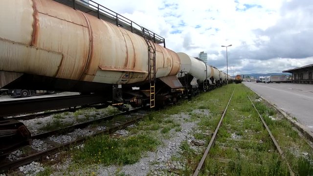 Left pan of wagons for liquids waits for further transportation on train depot