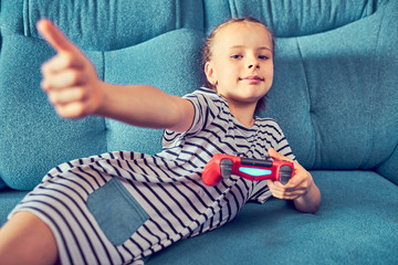 Young kids play video games on their own