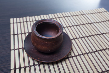 Empty clean pot on a bamboo mat.Copy space