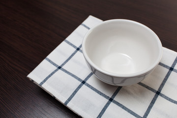 Empty clean bowl on a tablecloth.Copy space