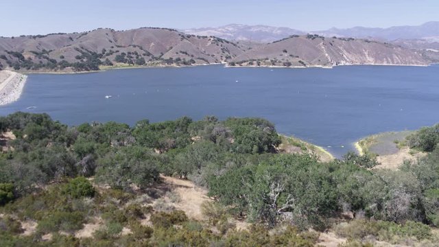 Aerial Drone Shot of a Trails Leading to a Lake and Dam (Cachuma Lake, California)