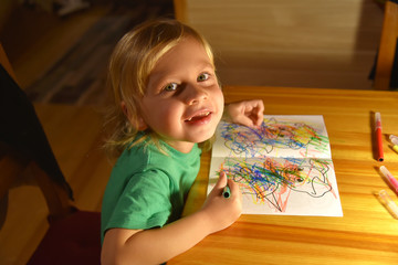 Boy, drawing a picture for father's day. Portrait of cute little boy drawing with brush.