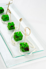 Top view catering banquet table with different food snacks and appetizers. Cold snacks, close up. Assorted canapes with caviar on a serving spoon iIsolated on white background.