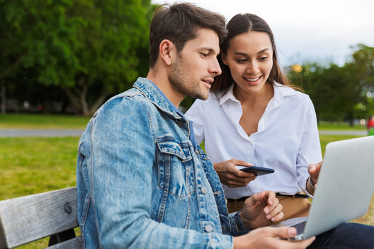 Attrative Young Couple Using Laptop Computer