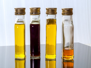 Vegetable oil in glass transparent bottles with screw caps