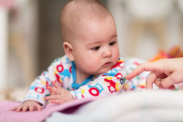 newborn baby boy playing on the floor