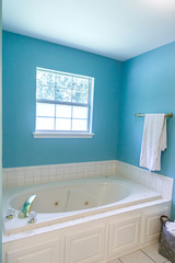 Bright blue colorful spacious master bathroom.