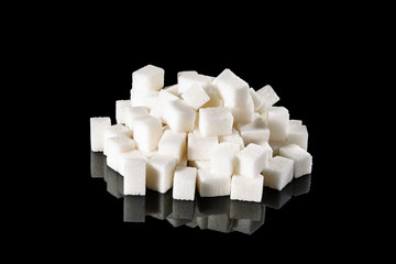 sugar cubes on a black mirror background