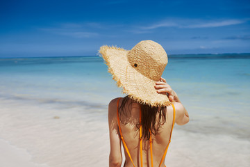 young woman in hat on the beach