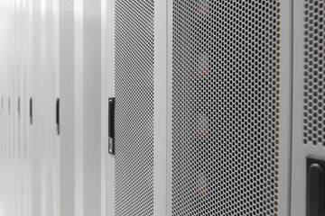 Data center white metal grid cabinet door side close-up