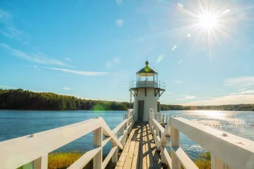  Lighthouse on the bay. Doubling Point Light is a lighthouse on the Kennebec River in Arrovich, Maine. USA. Maine. Beautiful green shores of the reservoir and the village bridge to the lighthouse. © Ann Stryzhekin