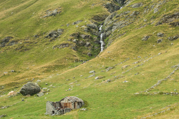 Mountain landscape with a typical italian  mountain cabin