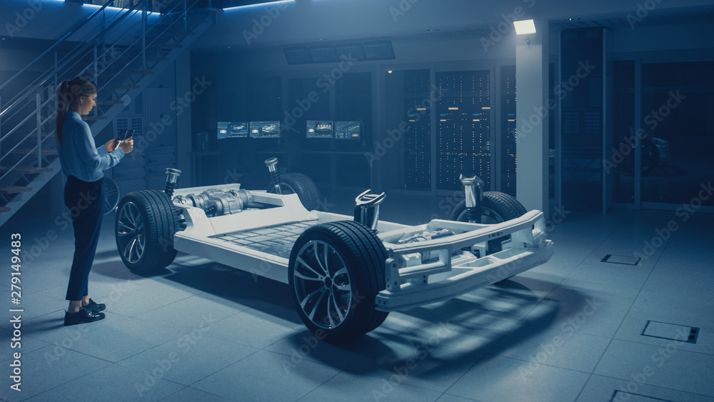 Poster Automobile Engineer Working on Electric Car Chassis Platform, Using Tablet Computer Augmented Reality with 3D CAD Software Modelling. Innovative Facility: Vehicle Frame with Wheels, Engine, Battery