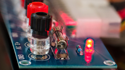 Power supply unit diagnostics. Electronic components detail on blue circuit board. Screw terminals,...