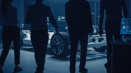 Team of Automobile Design Engineers Enter Automotive Innovation Facility Start Working on Electric...