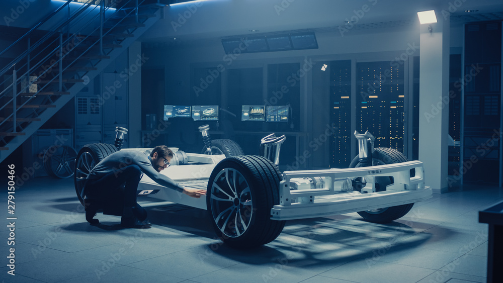 Poster Automobile Engineer Working on Electric Car Platform Chassis Prototype, Using Tablet Computer with 3D CAD Software Modelling. Innovative Facility: Vehicle Frame with Wheels, Battery and Suspension