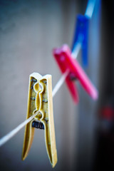 Clothes pegs on blue background