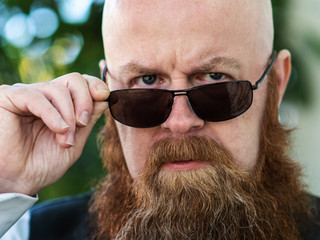 Portrait of angry beard man with sunglasses