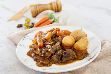 Beef meat stewed with potatoes-Traditional French cuisine Beef Bourguignon potatoes carrots in persillade