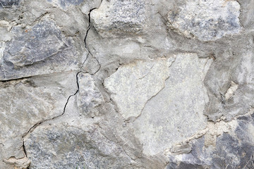 Gray concrete and stone background with crack