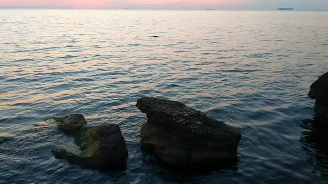 Sunset on the sea beach with stones