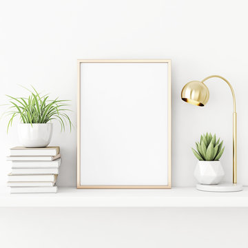 Interior poster mockup with vertical gold metal frame standing on the table with succulent plant, lamp and pile of books on empty white wall background. 3D rendering, illustration.